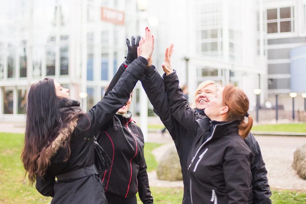 Women high fiving outside