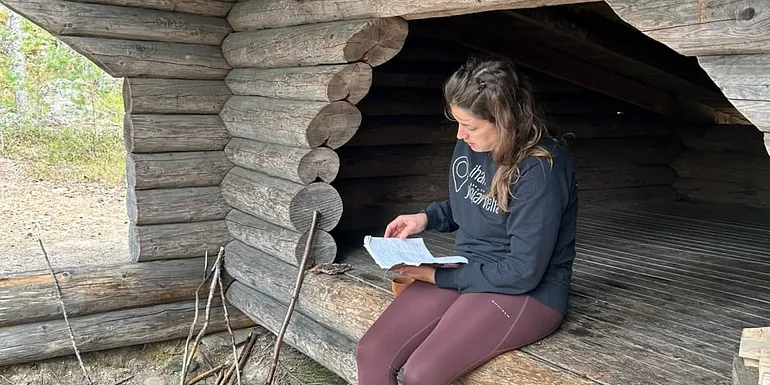 A person sitting by the campfire place