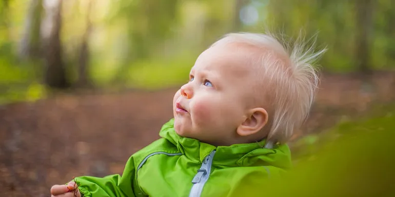 Child with green jacket.