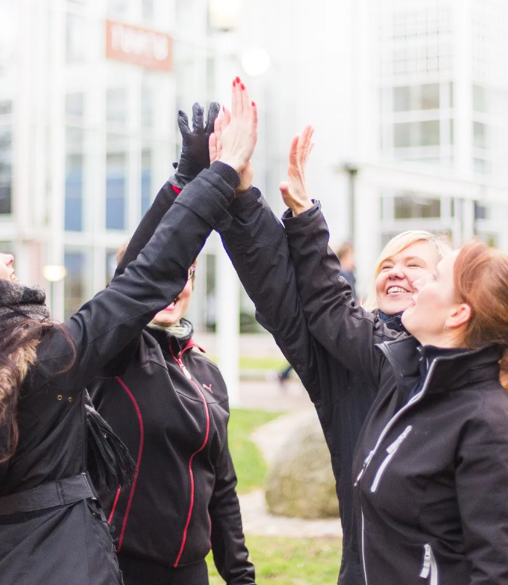 Women high fiving outside