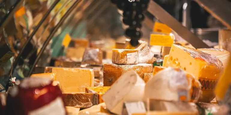 Shop counter with wide variety of cheese displayed