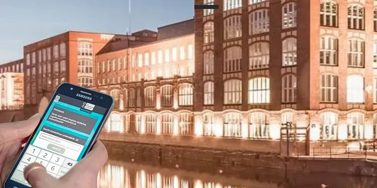 Phone in front of the landscape of Tammerkoski rapids