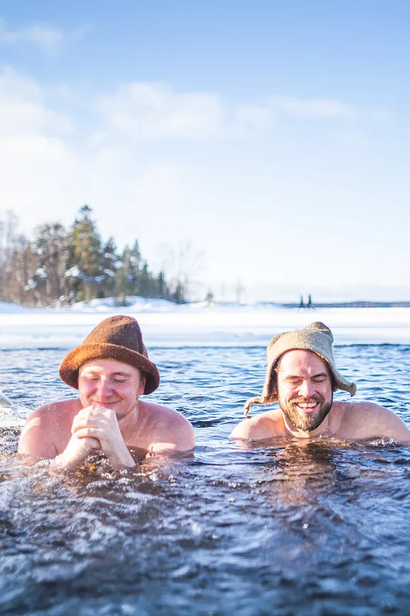 Two persons in a frozen lake enjoying themselves