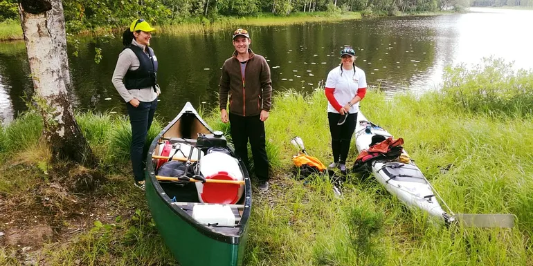 A group of people with canoe and kayak