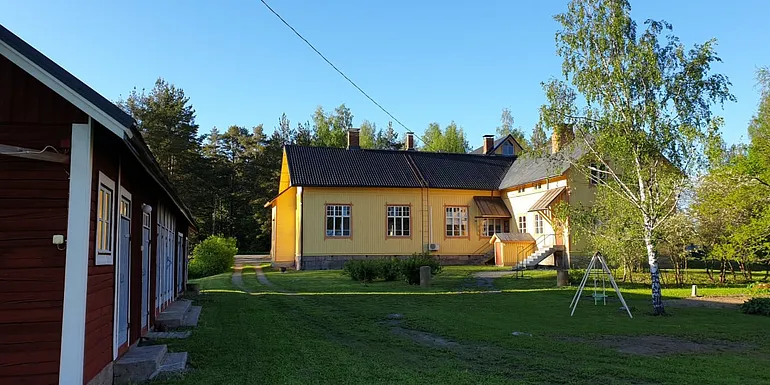 The school courtyard in front of the barn building