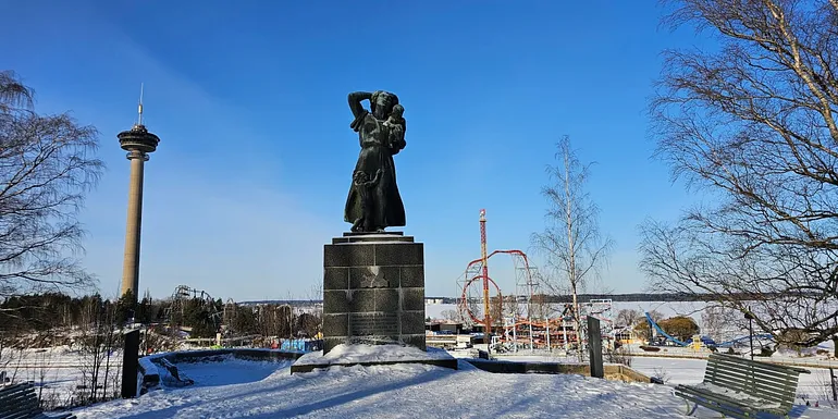 Statue on Näsinkallio hill with Särkänniemi on background