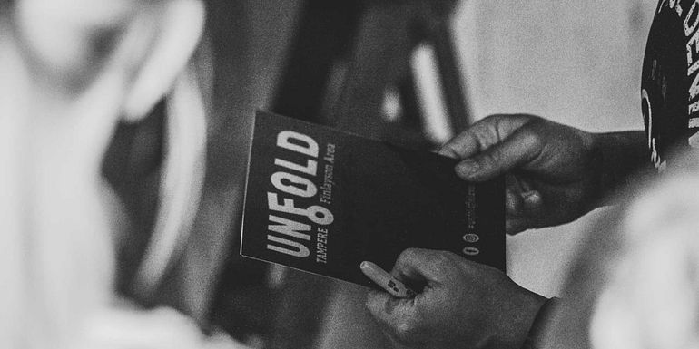 Players looking at the Unfold game book