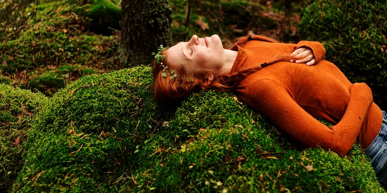Woman on a bed of moss