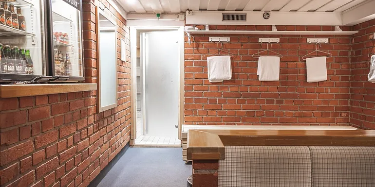 Brick wall, door to sauna, towels