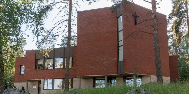 Tesoma Church is surrounded by a forest.